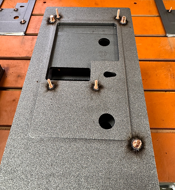 Electrical enclosure grounding studs welded with capacitive discharge stud welder